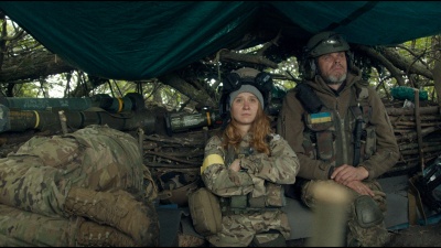 Young female soldier on duty with soldier friends.